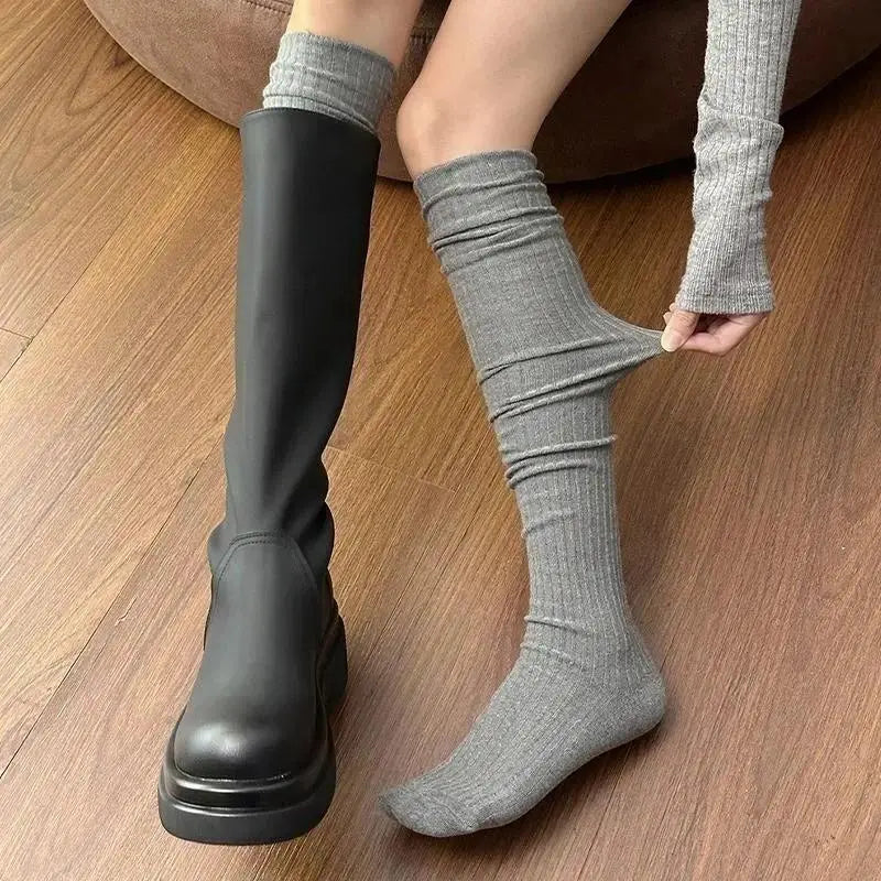 Grey stretch ribbed knee high sock showing flexible fit
